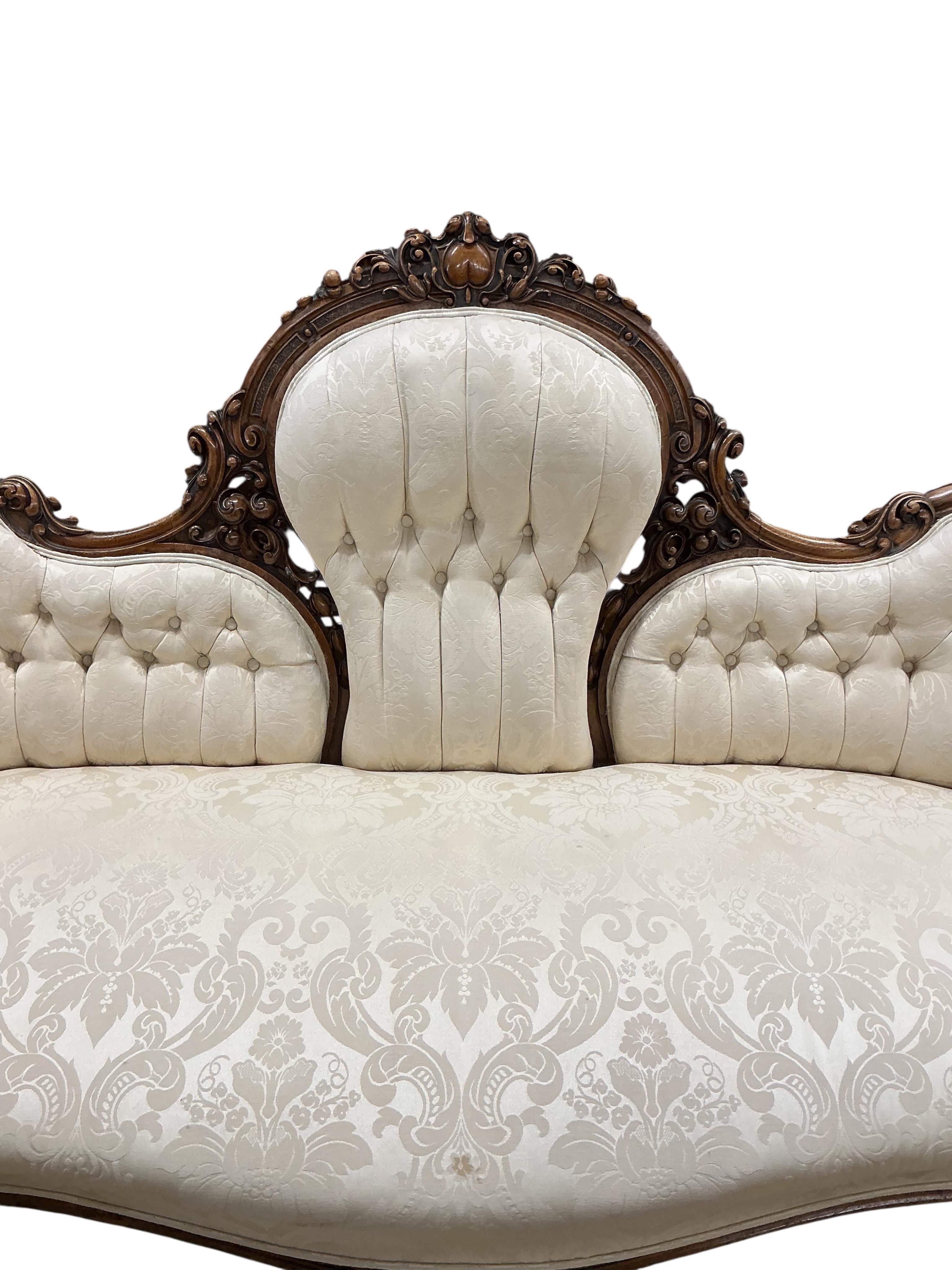 A Victorian carved mahogany walnut double spoon back settee, width 198cm, depth 79cm, height 101cm